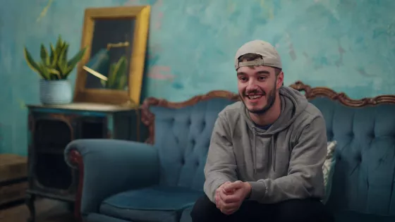young man smiling on a sofa