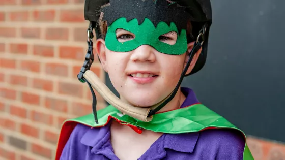 Young boy in superhero costume