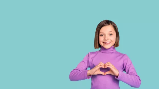 Blue background with cut out photograph of a little girl in a purple t-shirt making a heart with her hands in front of her chest