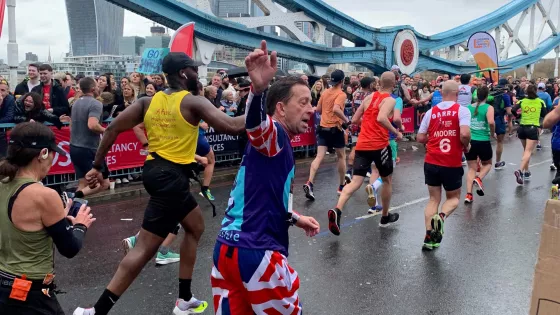 Man waving whilst running