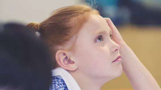 Photo of school student leaning on her hand