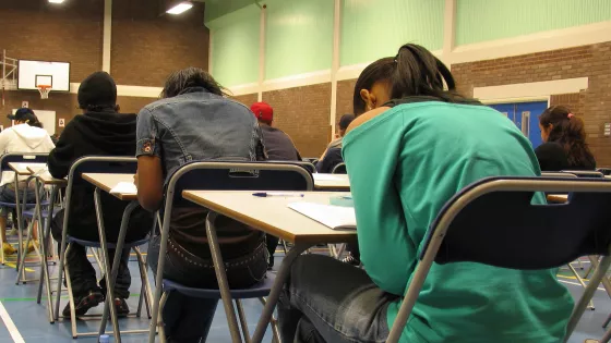 Photo of students sitting an exam in a sports hall