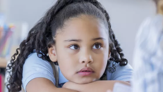 Photo of school student listening to an adult