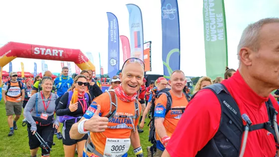 Runners smiling at camera at start line 