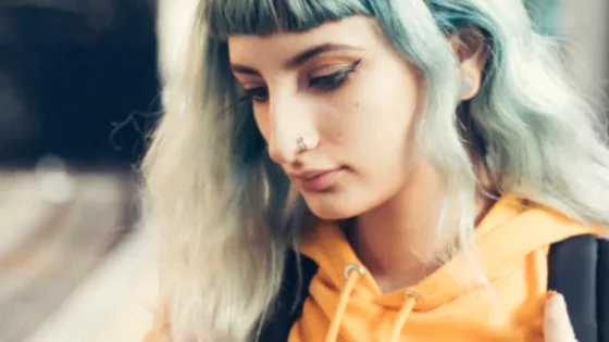 Photograph of a young woman looking at her mobile phone