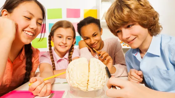 group of young children examining a brain at a virtual youth club for young epilepsy