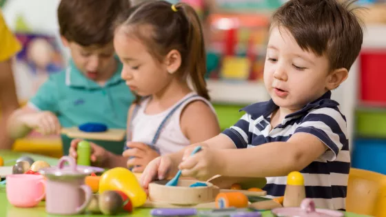 A group of young children playing with toys