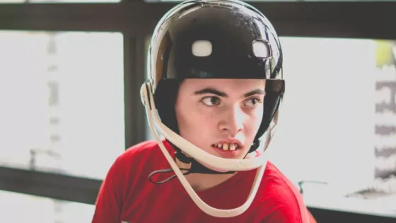 A young boy wearing a protective helmet