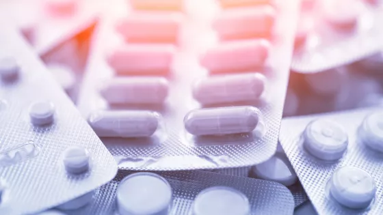 Sachets of medication sit on top of each other.