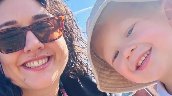 A mother and her sun smile in a selfie.