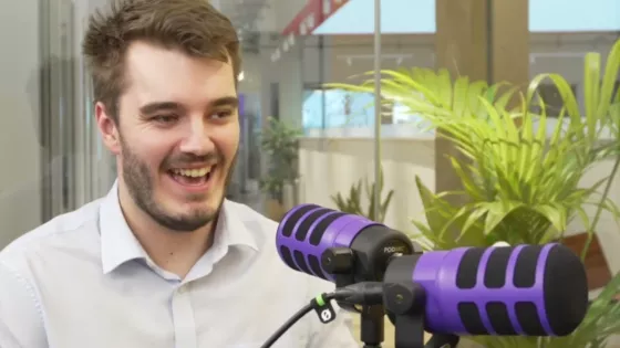 Young man smiling as he takes part in the Let's Talk About Epilepsy Podcast