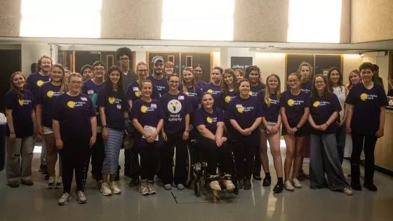 The Youth Voice Network smile as a group in a hall.