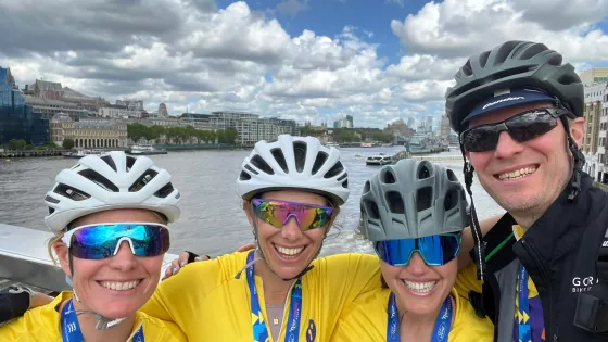 Happy cyclists in front of the Thames