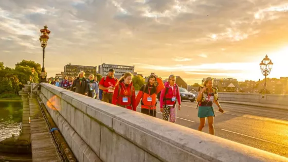 Walker on a bridge crossing the Thames