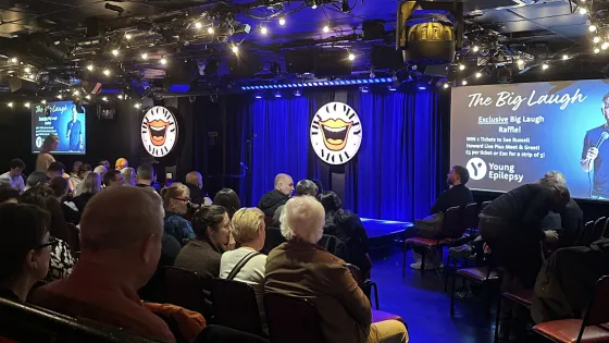 A crowd of patrons watch the stage of the Big Laugh night for Young Epilepsy at the Comedy Store.