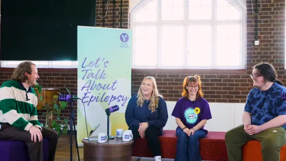 A group of young people are laughing on set of the Let's Talk About Epilepsy podcast.
