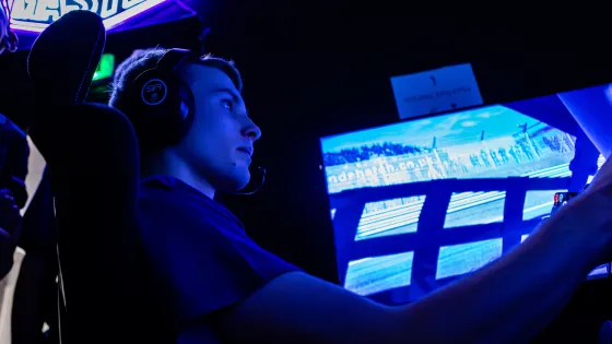 A young man races on a simulator.