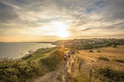 Walkers running along the Jurassic Coast