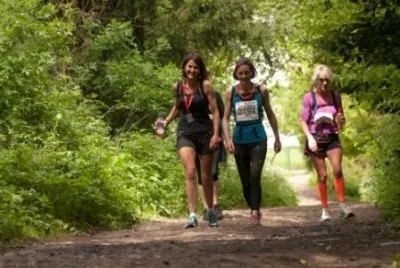 Women walking through trees