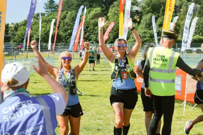 Women with arms raised running