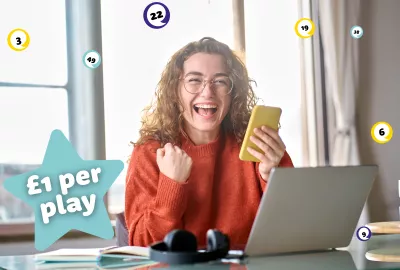 A woman in red on her phone celebrates winning the lottery