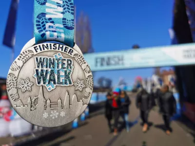 Winter walk medal in front of finish line