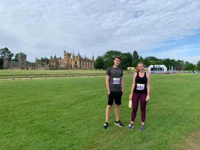 A man and woman representing Young Epilepsy at a sporting event smile in a field.
