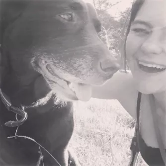 young girl smiling with dog
