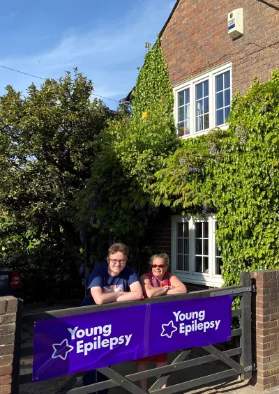 mother and son resting on a gate
