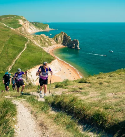 Walkers on a hill in front of Durdle Door
