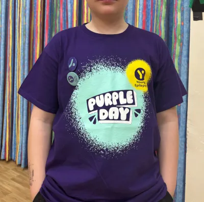 A young man wears a Purple Day.