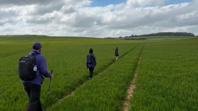 A family walks through a beautiful rural field.