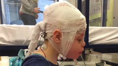 A young boy gets an EEG.
