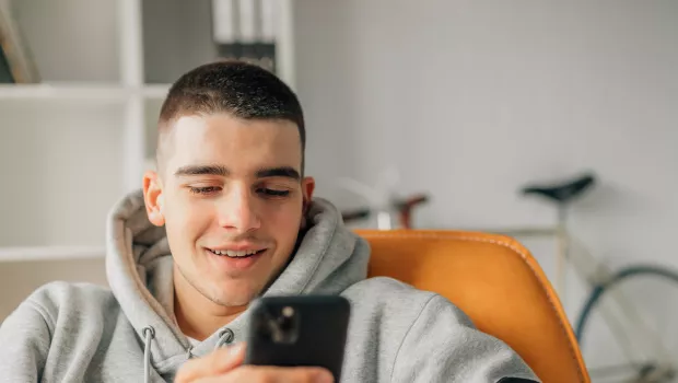 Young boy smiling on a video call on his mobile phone
