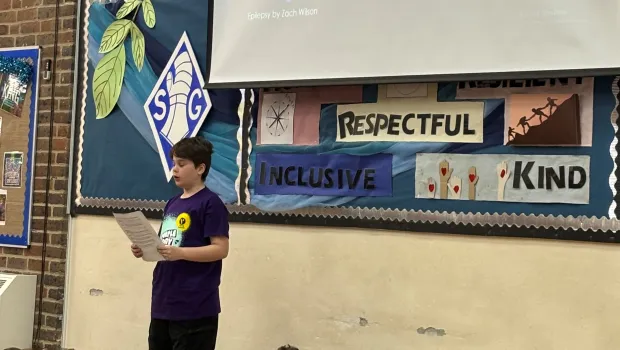 A boy presents an epilepsy assembly.