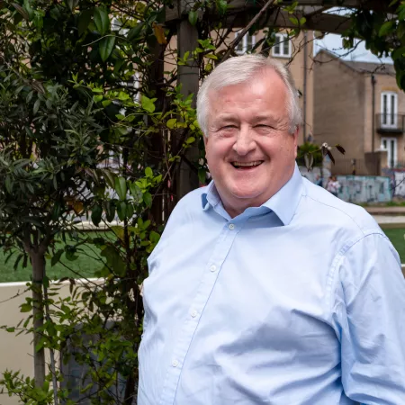 Profile photograph of Simon Neville taken outside in a garden