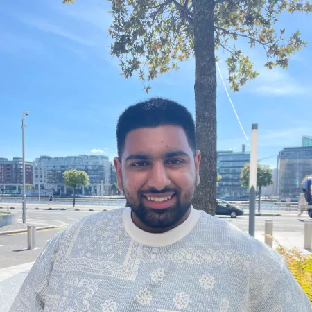 Photograph of a young man smiling directly at the camera. Zaid, is a Young Rep and Young Trustee at Young Epilepsy. 