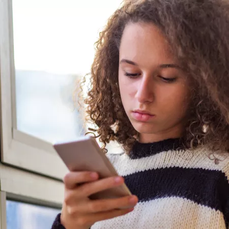 Young girl using her mobile phone