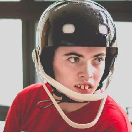 A young boy wearing a protective helmet