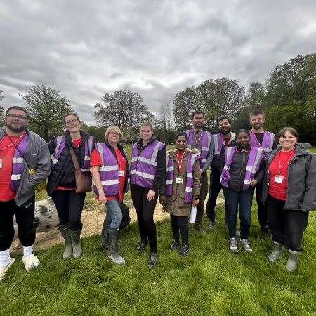 Group of Corporate Volunteers Standing with work jackets on happy