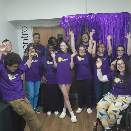 Members of Youth Voice all cheer while wearing purple Young Epilepsy t-shirts.