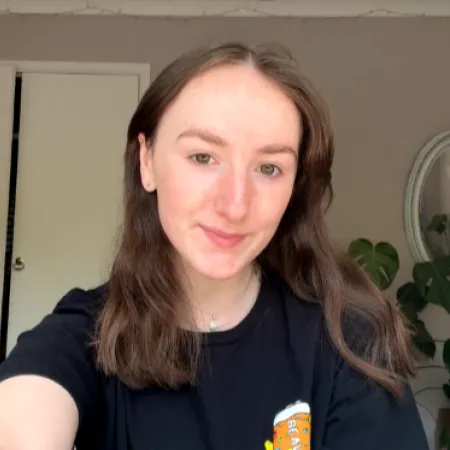 A young woman smiles in a selfie.