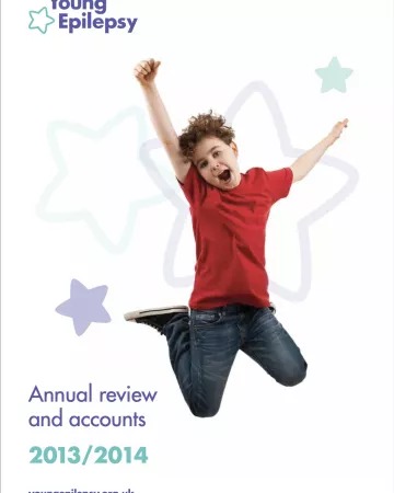A boy jumps for joy on the Young Epilepsy Annual Report 13-14 cover.