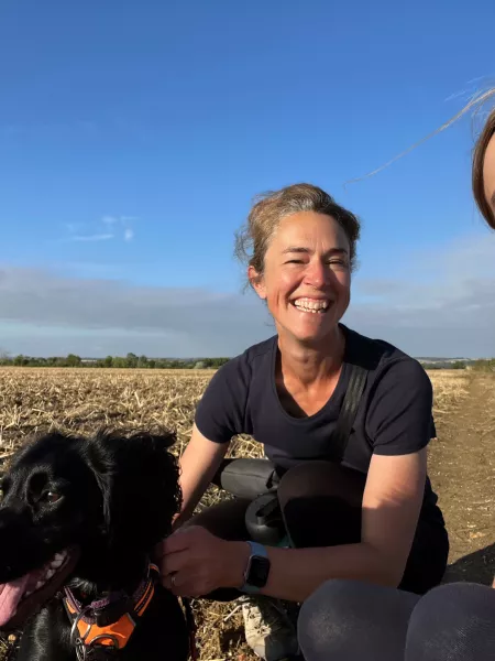 2 women smiling with dog