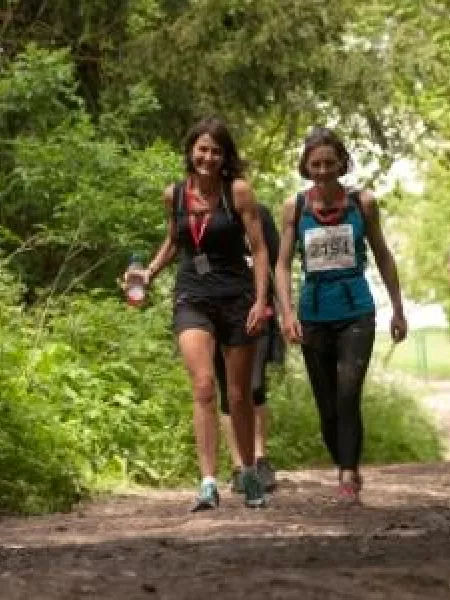 Women walking through trees