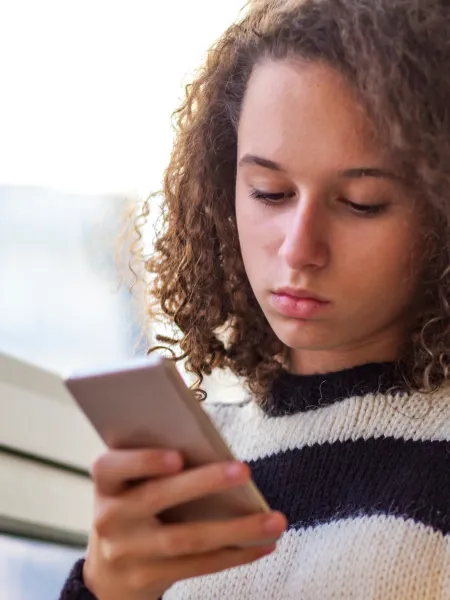 Young girl using her mobile phone