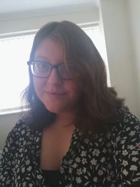 Young Epilepsy contributor Annie Davidson, a brown haired woman wearing glasses, smiles in a selfie.