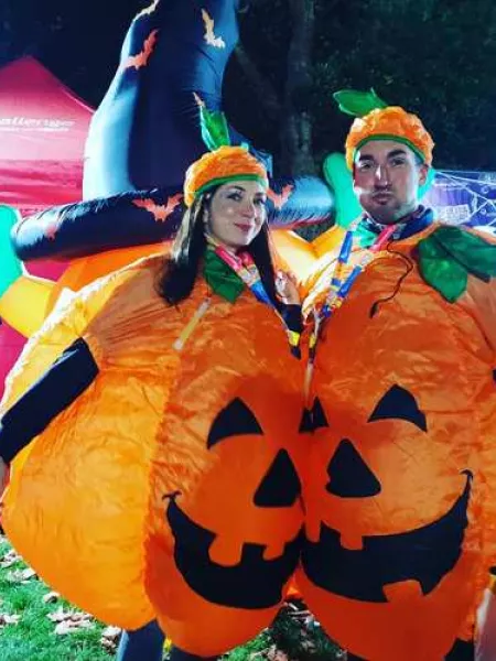 A couple in inflatable pumpkin costumes
