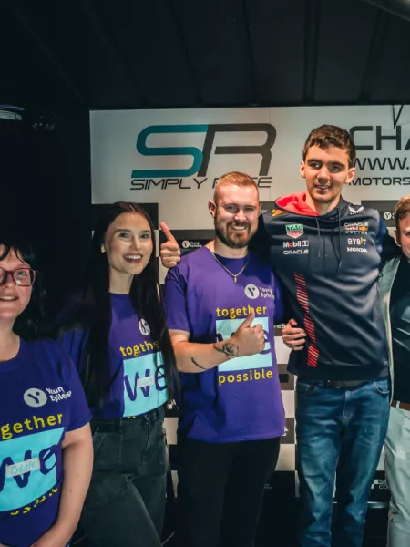Young people wearing Young Epilepsy tops and smiling at the camera