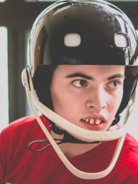 A young boy wearing a protective helmet